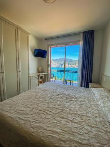 a bedroom with a large bed with a view of the ocean at Villa Emma Malcesine in Malcesine +77 photos
