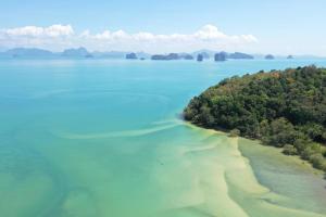 a large body of water with trees at Koh Yao Seaview Bungalow in Ko Yao Noi