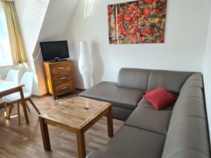 a living room with a couch and a table at Seevilla Wietjes Whg 5 in Baltrum