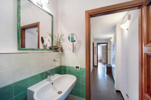 a bathroom with a sink and a mirror at Appartamento La Buraggia in Diano San Pietro +17 photos
