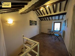 a room with a table and chairs and a window at Yellow Corner in Bagni di Lucca
