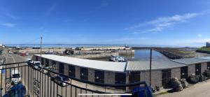 un edificio con puerto deportivo junto al agua en Anchor Point, en Seahouses 2 fotos más