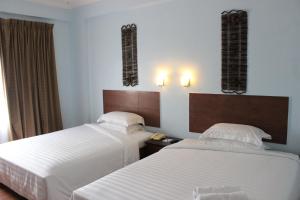 Postel nebo postele na pokoji v ubytování Hotel Maluri
