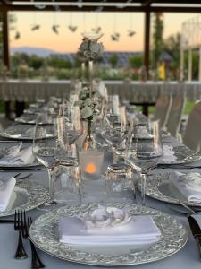 a long table with plates and glasses on it at Agrisalotto in Cortona