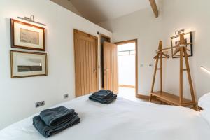 a bedroom with a bed with two towels on it at Finest Retreats - Elwell Stables West in Dundry