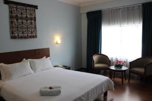 Postel nebo postele na pokoji v ubytování Hotel Maluri