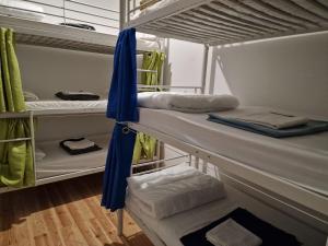 a room with three bunk beds with towels on them at D&N Hospedagem Lisboa in Lisbon