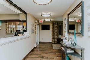 a hallway of a hospital with a counter and a mirror at Sonesta Simply Suites Minneapolis Richfield in Richfield