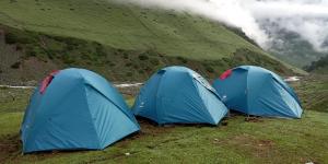 two blue tents sitting in a field in a mountain at Kashmir Outlook Adventures in Pahalgām