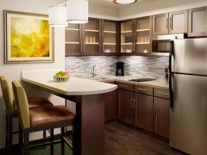 a kitchen with a refrigerator, stove, sink, and dishwasher at Sonesta ES Suites Toronto Markham in Thornhill