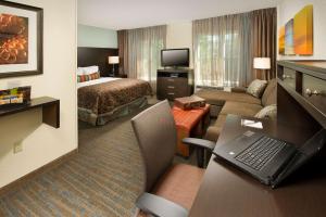 a hotel room with a bed, desk and television at Sonesta ES Suites Toronto Markham in Thornhill