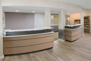 a large kitchen with wooden floors and a counter top at Sonesta ES Suites Albuquerque in Albuquerque