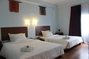 Postel nebo postele na pokoji v ubytování Hotel Maluri