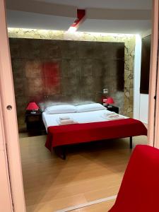 a bedroom with a red bed and a red wall at Le Torri in Cagliari