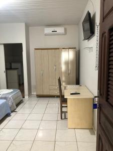 a room with a desk and a bed and a room with a bed sqor at Pousada Cristo Rei in Parnaíba