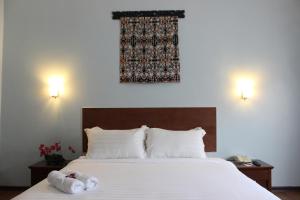 Postel nebo postele na pokoji v ubytování Hotel Maluri