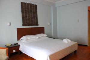 Postel nebo postele na pokoji v ubytování Hotel Maluri