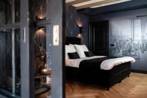 una camera con un letto bianco e nero di B&B De Edelsmederij a Schoonhoven