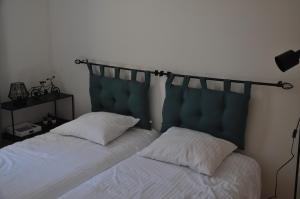 a bedroom with two beds with a headboard and white sheets at Villa Côte & Provence - private heated pool in Fayence +16 photos