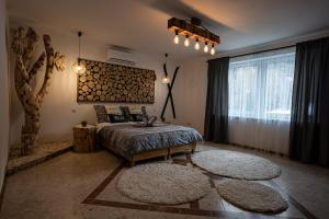 a bedroom with a bed and two rugs at Apartamenty Na Szlaku in Iwonicz-Zdrój