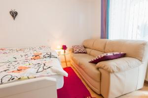 a living room with a couch and a bed at DREAM Bled Apartments in Bled