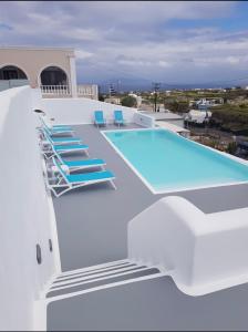 a swimming pool on the roof of a house at Evas House in Fira