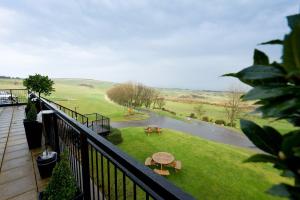 a balcony with a view of a park with a table at Hunley Golf Club in Saltburn-by-the-Sea +6 photos