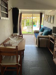 a living room with a table and a couch at Quintinha do Zé da Lola in Silveiras