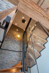 a view of the stairs in a building with a brick wall at Le Refuge des Sens chalet Quiétude in Vaujany