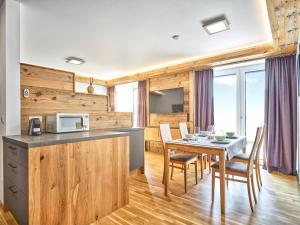 a kitchen and dining room with a table and a microwave at The Spa Suite Top 3- Tauplitz Residences by AAHH in Tauplitz