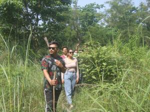 un grupo de tres personas de pie en la hierba alta en Mango Tree Lodge, en Bhurkīā