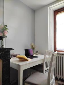 a white desk with a laptop computer on top of it at Maison de village - Suite Baroque cosy et élégante à 1 h de Paris proche Fontainebleau 