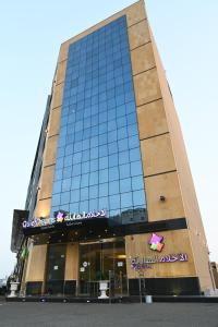 a building with a sign on the front of it at Quiet Dreams - King Road Branch in Jeddah