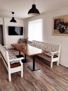 a dining room with a table and two chairs at Ubytování Valentovi in Veľký Meder