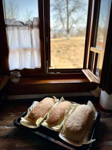 a tray of sandwiches sitting in front of a window at Pensiunea Agroturistica Casa Pribegilor in Breb