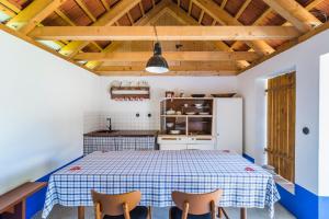 a kitchen with a table and two chairs at Penzion Berdina in Suchá Loz