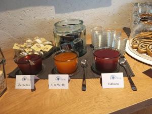 a table topped with different types of tea and desserts at Feriendorf Edelweiss in Mariapfarr