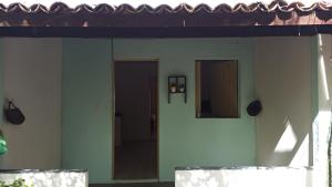 a room with two doors on the side of a house at Quitinetes Beira Rio in Canindé de São Francisco