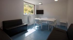 a living room with a table and a couch at Private Bedrooms with Shared Kitchen at East Shore in St Andrews in St. Andrews