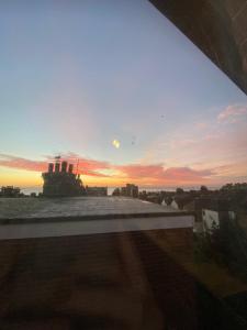 a view of a sunset from the roof of a building at Seaside Apartment in Ramsgate