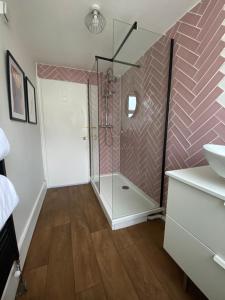 a bathroom with a shower with a glass door at Seaside Apartment in Ramsgate