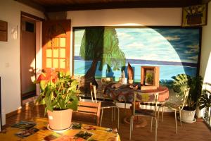 a living room with a painting on the wall at HORIZON 180° in Le Bois de Nèfles
