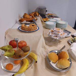 una mesa cubierta con platos de comida y fruta en Hotel Pixunte en Policastro Bussentino