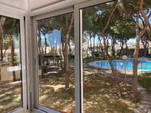 a view of a pool from a window at Studio Pinar in Sitio de Calahonda
