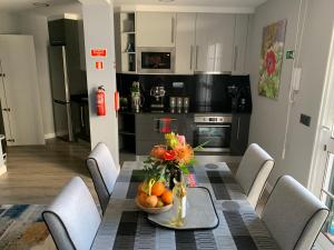 a kitchen with a table with a bowl of fruit on it at Beautiful 1-Bed Apartment in Funchal Madeira in Funchal
