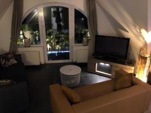 TV a/nebo společenská místnost v ubytování B&B wellness Sea Nat voor Naturisten