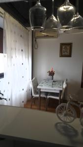 a table and chairs in a room with a window at Mamaia Coral Patrick Summerland in Mamaia