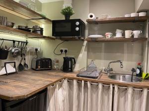 a kitchen with a sink and a counter top at contemporary quiet countryside retreat in Horsley