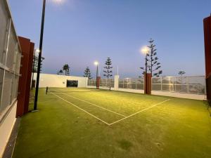 a tennis court with lights on top of it at Beachside Villa 7.1 in Mandurah
