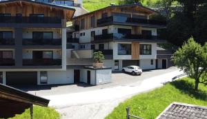 a car parked in front of a building at Grand Alpin Panorama Lodge Top 3 in Hart im Zillertal